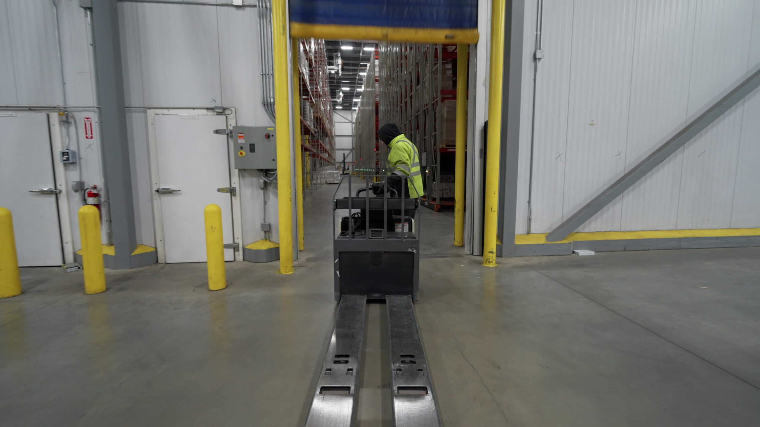 Racking pallets at the doc in the cold storage warehouse